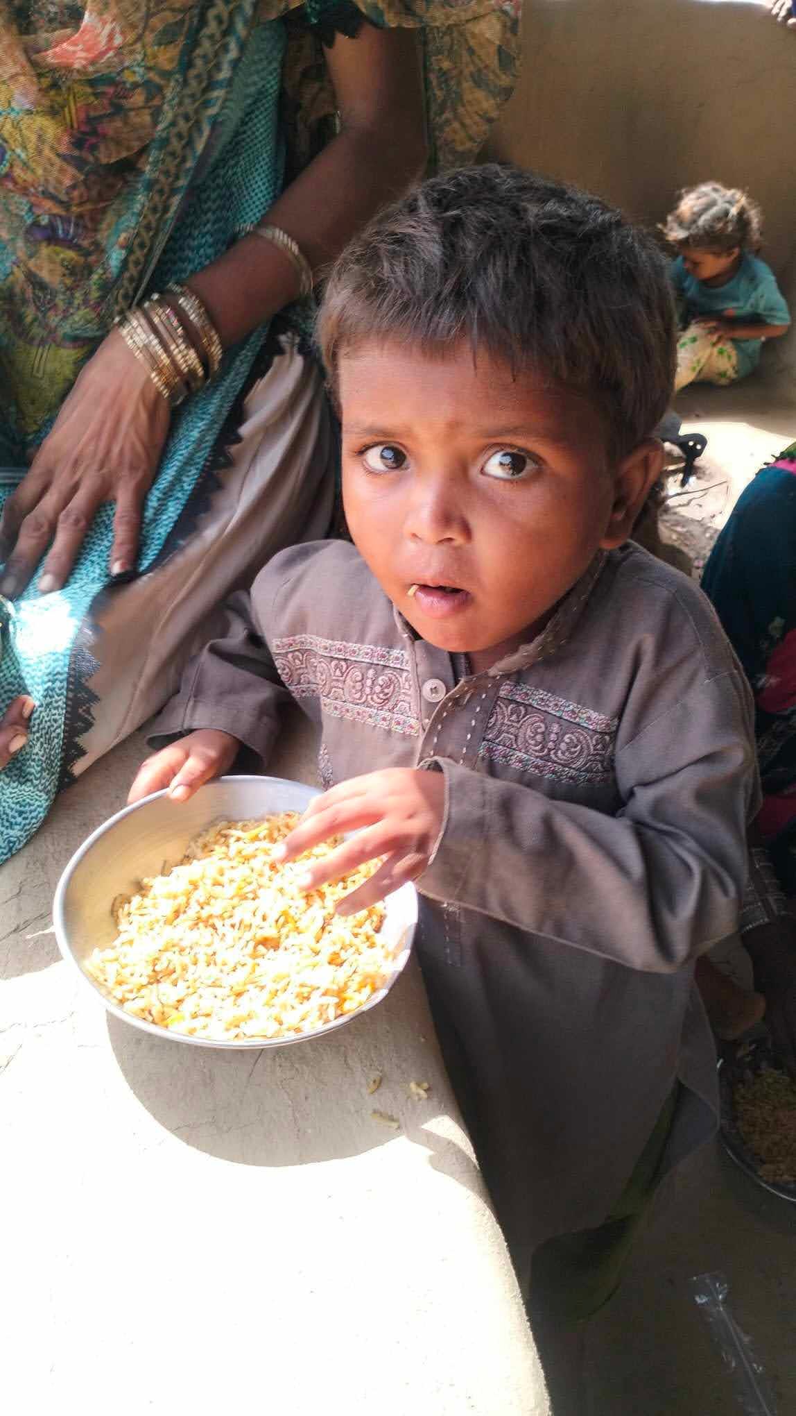 A child receiving food during a village visit